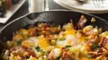 Tasty Breakfast Skillet With Bacon, Egg, Potato, And Cheese Tasty Breakfast Skillet With Bacon, Egg, Potato, And Cheese